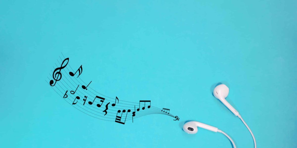 white earphones with notes on a blue background